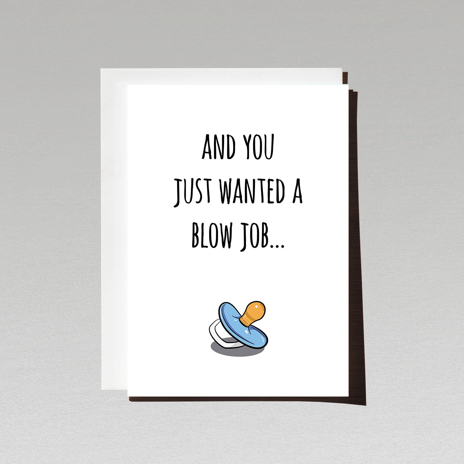 pregnancy reveal greeting card with blue pacifier on white background with text and you just wanted a blow job